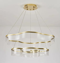 Gold and clear glass pendant light fixture on a white background