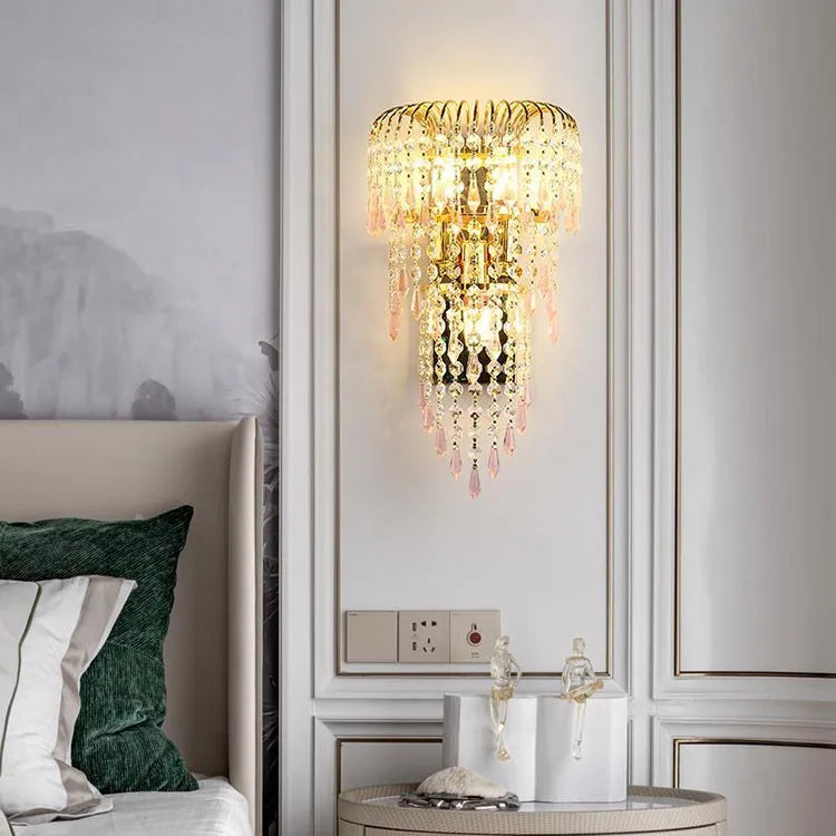 Decorative wall light fixture in a bedroom setting with a bed and nightstand.