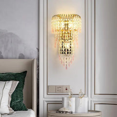 Decorative wall light fixture in a bedroom setting with a bed and nightstand.