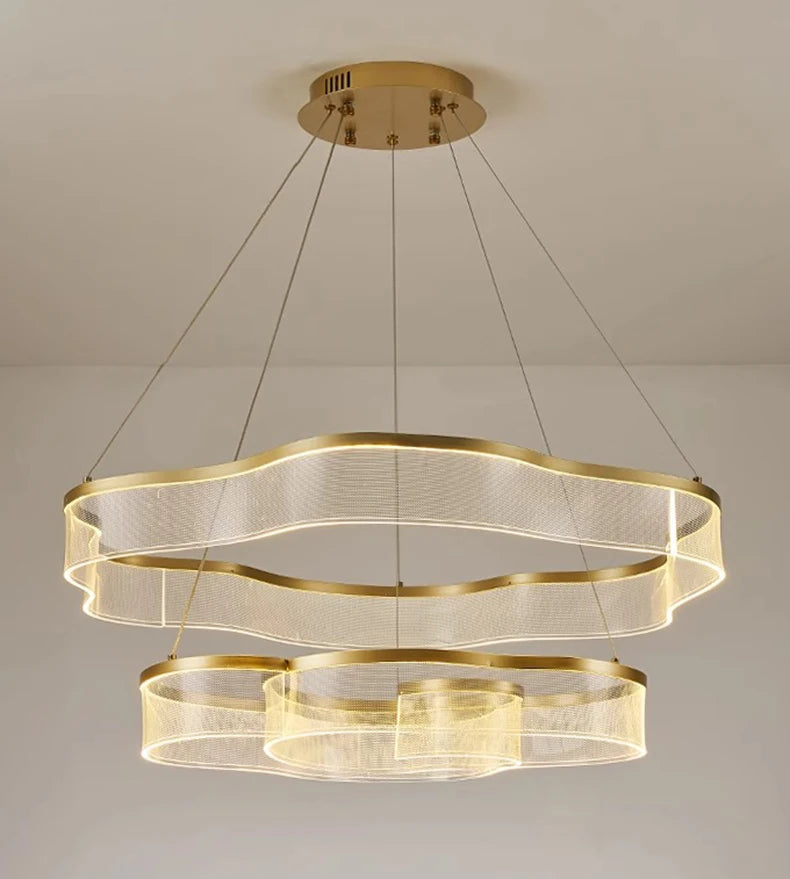 Gold chandelier with multiple rings on a neutral background