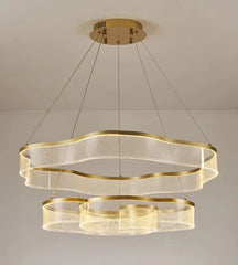 Gold chandelier with multiple rings on a neutral background