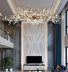 Luxurious living room with a large chandelier, marble wall, and modern furniture.