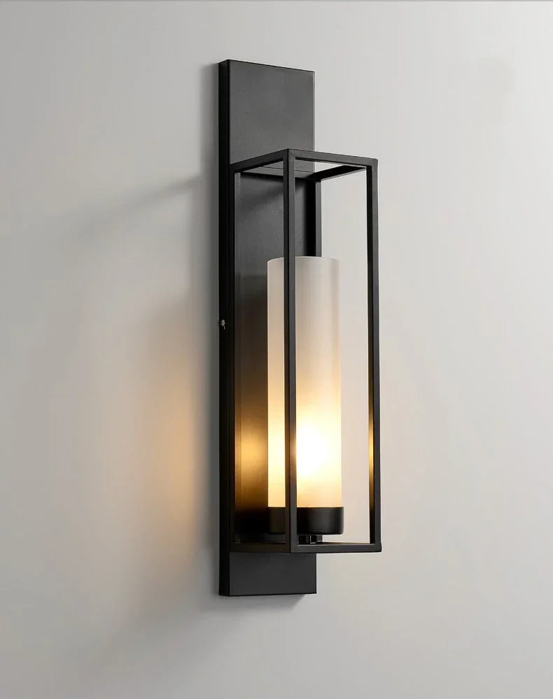 Modern wall-mounted light fixture with glass cover on a gray background