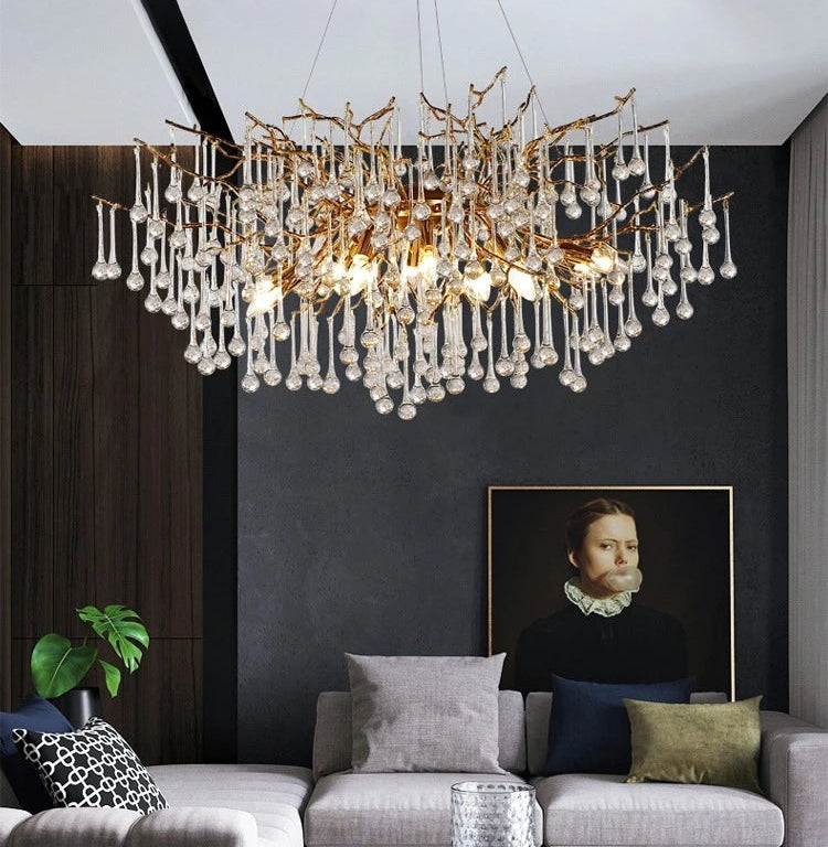 Modern living room with a chandelier, sofa, and decorative elements.