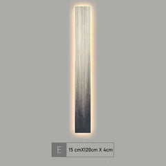 Wall-mounted light fixture with a gradient design on a gray background