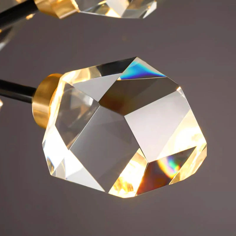 Close-up of a gold and crystal pendant light fixture on a dark background