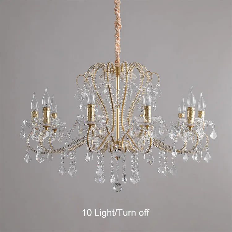 Gold chandelier with crystal accents on a gray background