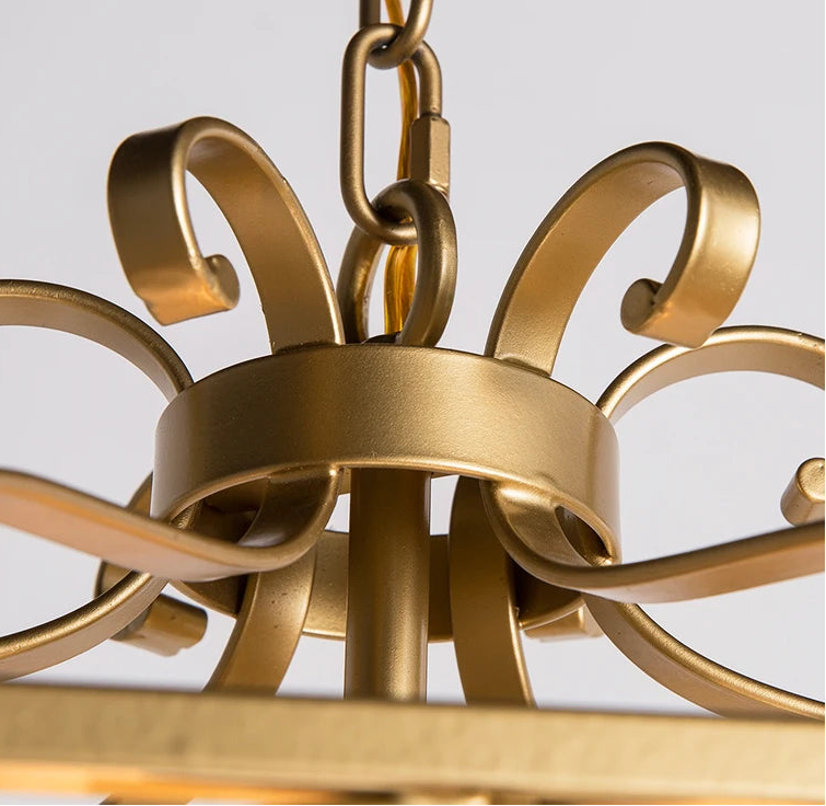 Gold chandelier with intricate design on a light gray background.