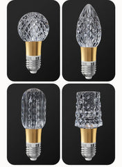 Four crystal light bulbs on a black background