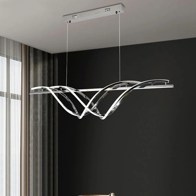 Modern pendant light hanging in a room with a dark wall and window.