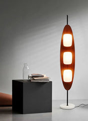Modern floor lamp with three illuminated sections on a gray background