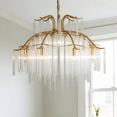Close-up view of the gold-finished tiered chandelier, showcasing the arrangement of clear glass rods and the central gold frame.
