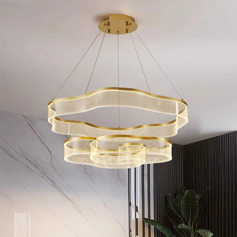 Modern gold pendant light fixture hanging from the ceiling.
