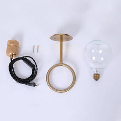 Gold pendant light fixture with bulb and wiring on a white background