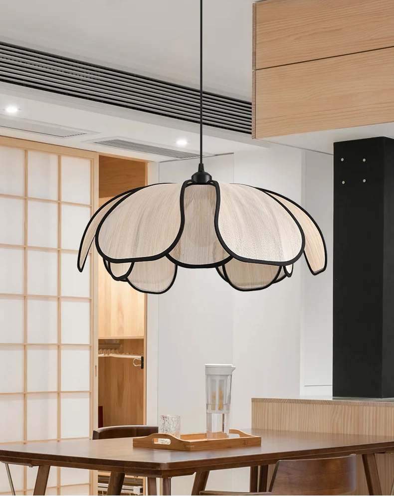 Modern pendant light fixture hanging above a dining table in a stylish interior setting.