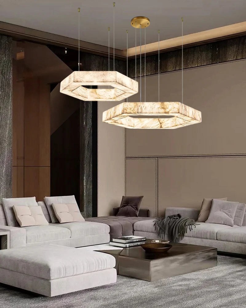 Modern living room with gray sectional sofa, coffee table, and two hexagonal pendant lights.