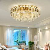 Gold crystal tiered cascading chandelier in a living room setting.