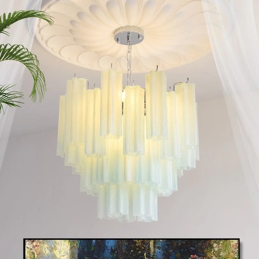 A tiered chandelier with many vertical, translucent, pale yellow glass rods hanging from a chrome base, illuminated from within.
