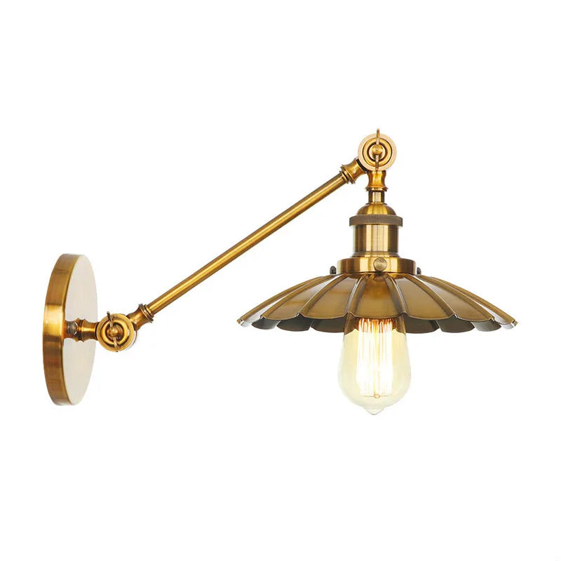 Two brushed gold cone shade wall sconces mounted side-by-side on a circular backplate