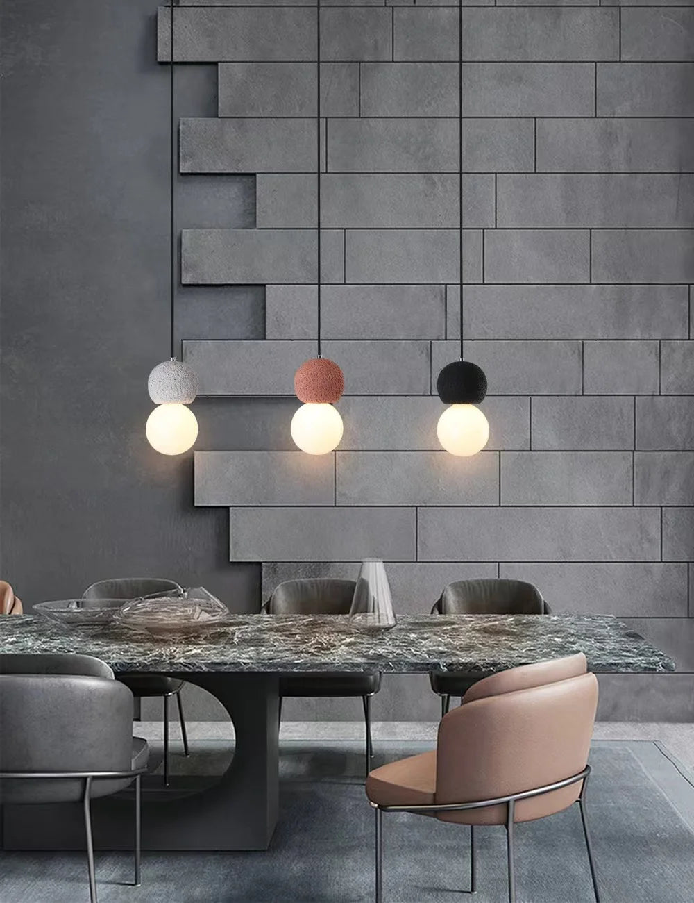 Modern dining room with a marble table and gray chairs against a textured gray wall.