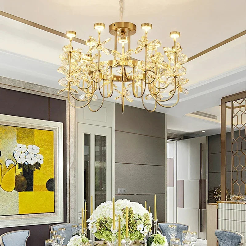 Luxurious chandelier hanging in a modern dining room with artwork and decor.