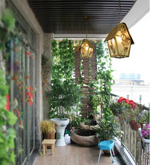Balcony with plants, a small pond, and decorative lights.