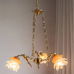 A close-up view of the central part of a copper chandelier, showing the connection of chains, angel figures, and flower shades.