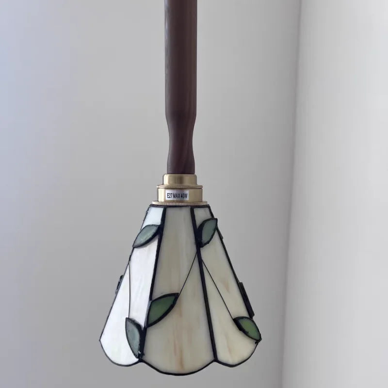 Stained glass lamp with floral design on a plain background