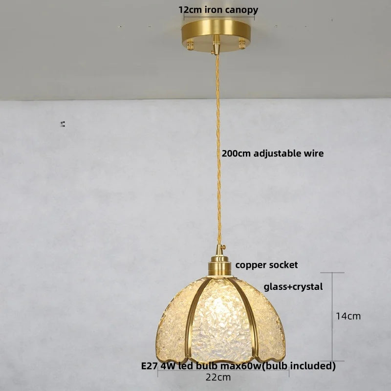 Gold pendant light with measurements and details on a gray background