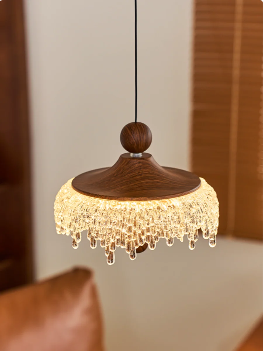 Wooden pendant light with crystal details hanging in a room.