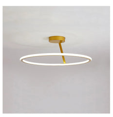 Ceiling light fixture with gold finish and white ring on a gray background