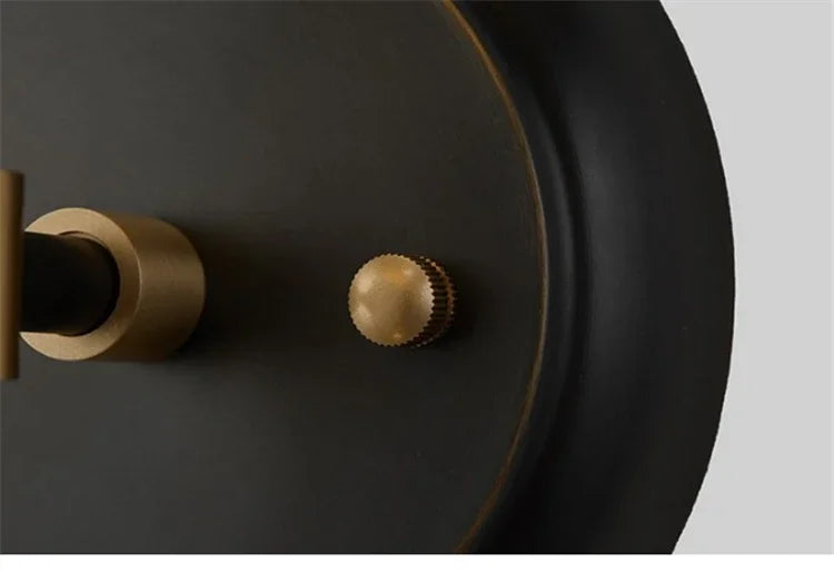 Close-up of a black and gold wall light fixture