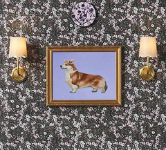 Floral-patterned wall with framed picture of a dog, two floral chairs, and wall sconces.