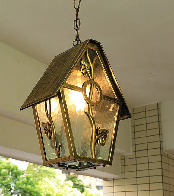 Decorative hanging light fixture with a warm glow, mounted on a ceiling.