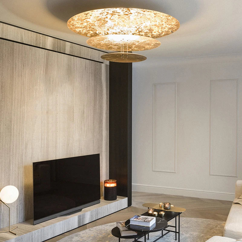 Modern living room with a stylish chandelier, TV, and coffee table.