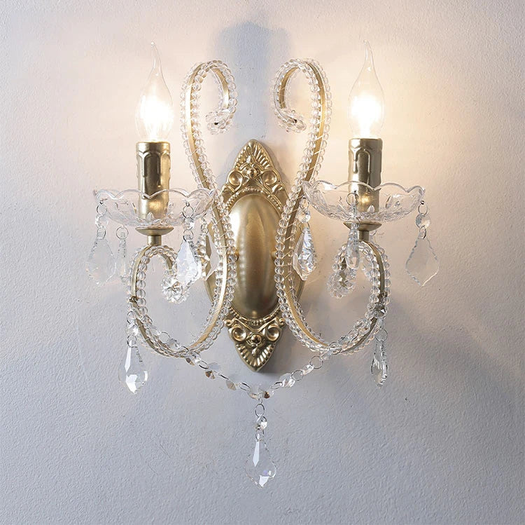 Decorative wall sconce with crystal accents on a white wall
