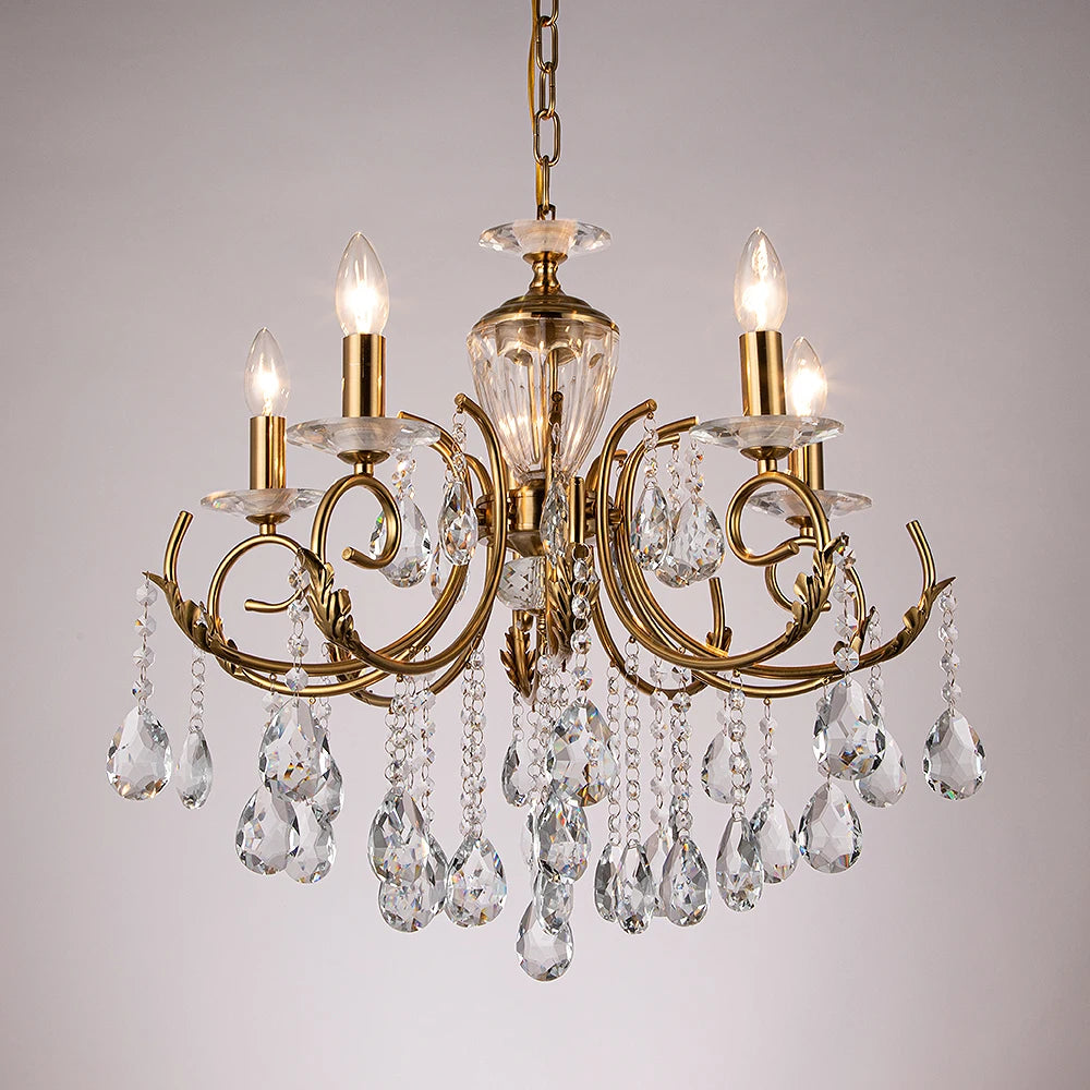 A gold candelabra crystal chandelier with multiple arms and crystal accents, viewed from a side angle.
