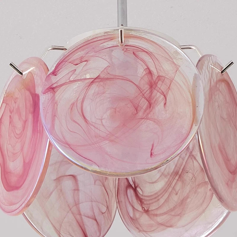 A green floral glass pendant light casting warm, neutral, and white light on the ceiling in a four-panel display.