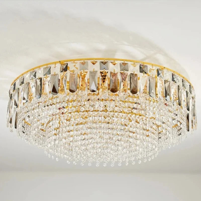 Overhead view of the gold crystal tiered cascading chandelier mounted on a white ceiling.