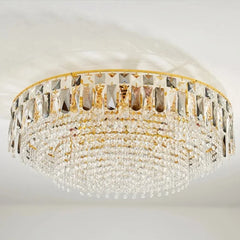 Overhead view of the gold crystal tiered cascading chandelier mounted on a white ceiling.