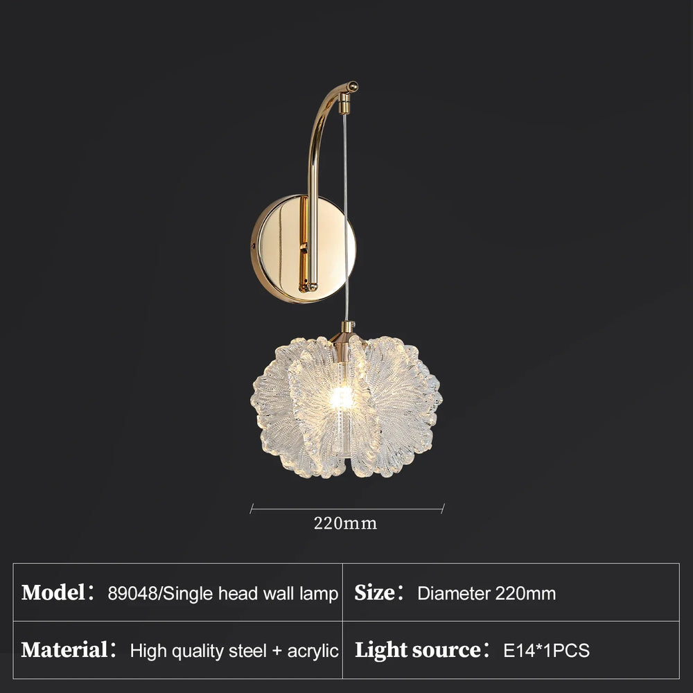 Wall-mounted lamp with decorative glass shade on a black background