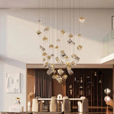A large, multi-tiered gold and crystal cube chandelier hanging from a high ceiling in a modern living room.