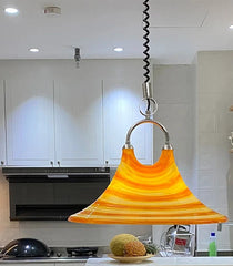 Modern kitchen featuring a unique pendant light.