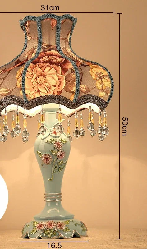 Decorative table lamp with floral design and remote control on a beige background