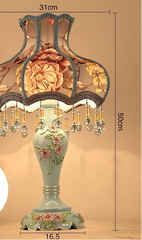 Decorative table lamp with floral design and remote control on a beige background