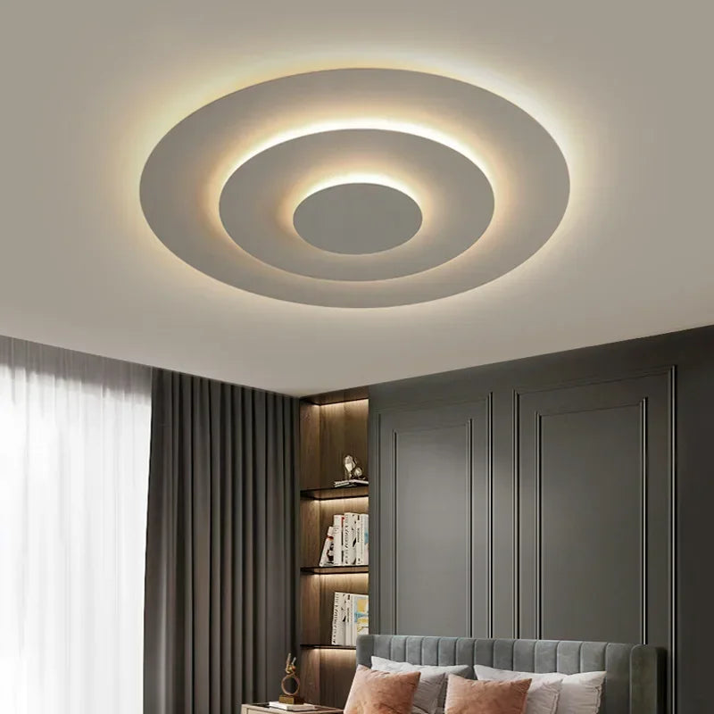 Interior shot of a bedroom showcasing the modern flush mount ceiling light installed on a white ceiling, providing ambient lighting.