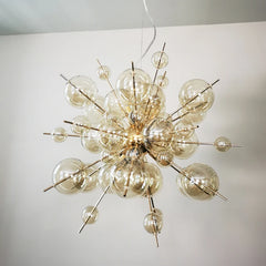 Modern chandelier with glass bulbs on a plain background