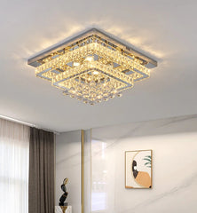 Modern square ceiling light fixture in a room setting with decor elements.