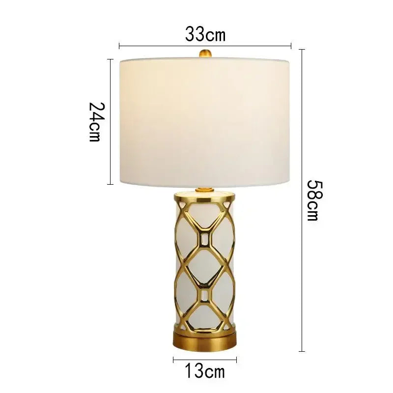 Table lamp with gold base and white shade, shown with dimensions on a white background