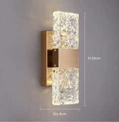 Decorative wall light fixture with crystal design on a gray background